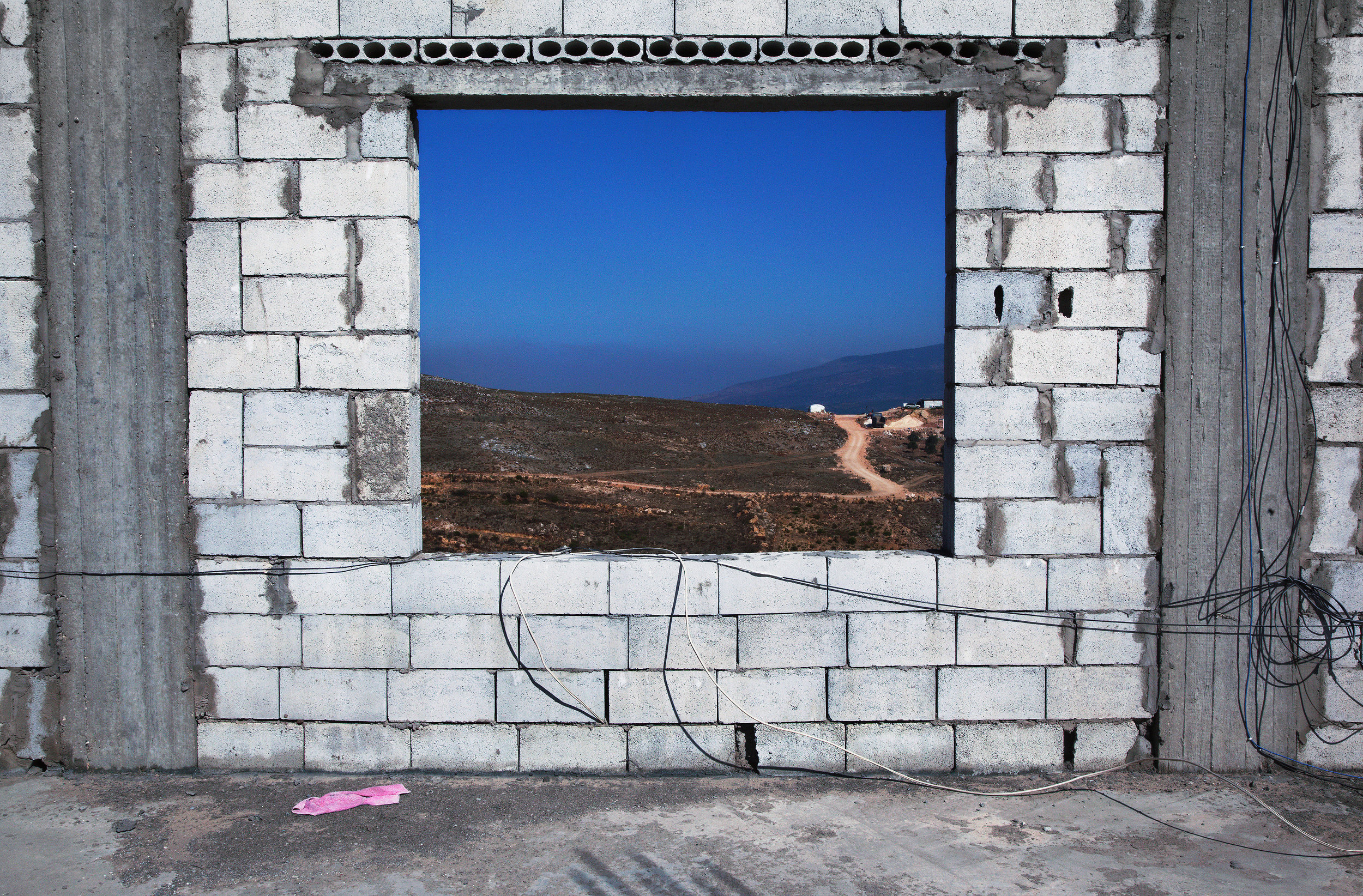 Wall , 2014, vinyl wallpaper (photograph taken in Marjayoun, Lebanon, 2013), 96"x 144" (243.8 cm x 365.8 cm)