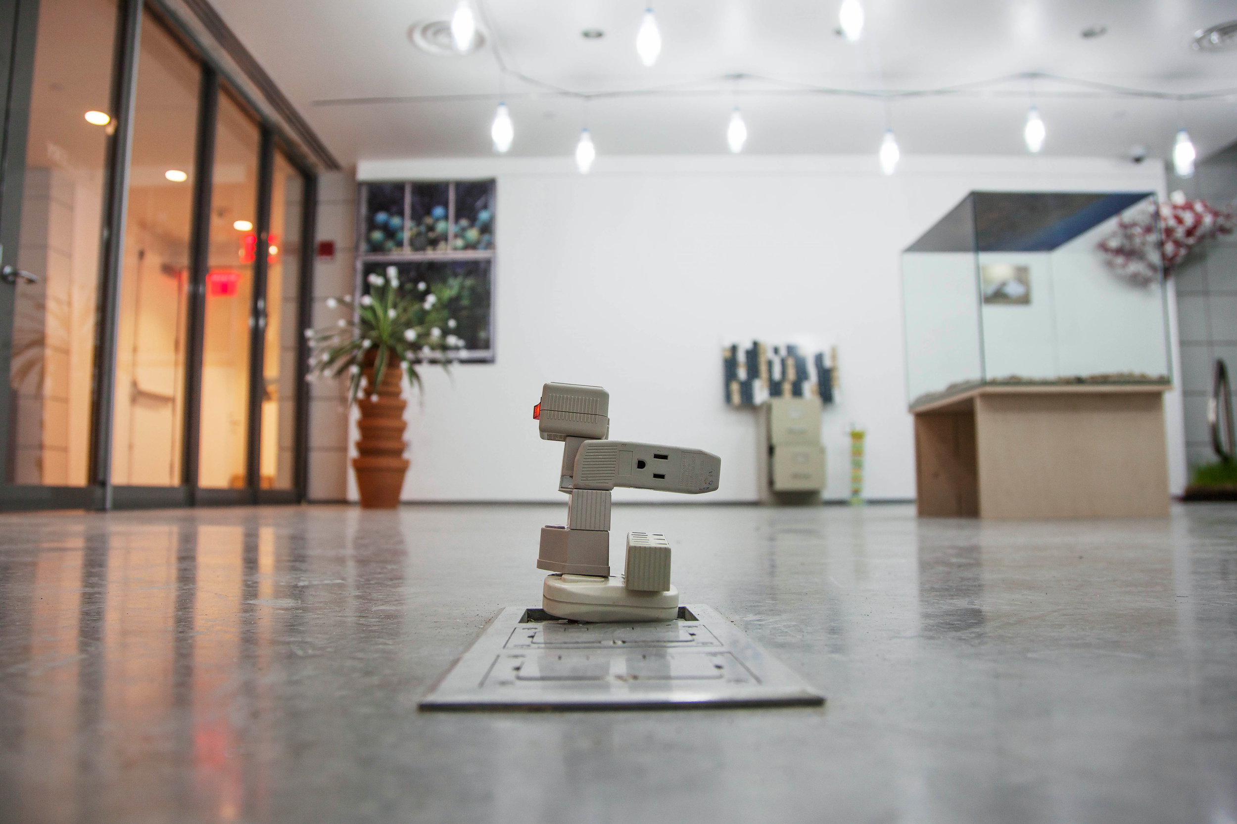 Installation view, Plugin Adapter , 2014, outlet adapters, 3"x 3"x 4" (7.6 cm x 7.6 cm x 10.2 cm)