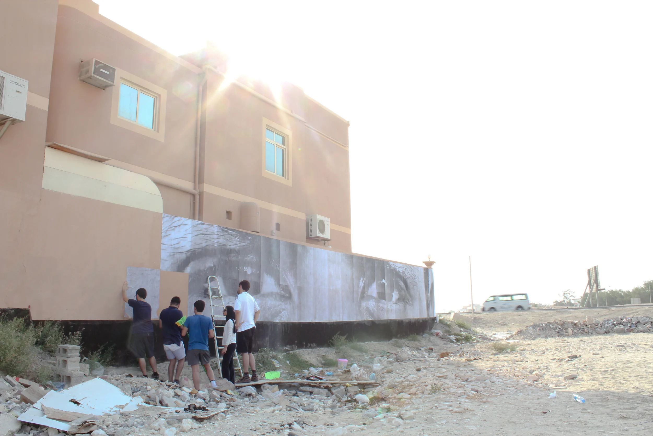 Silver Cord Team working on their mural in A'ali
