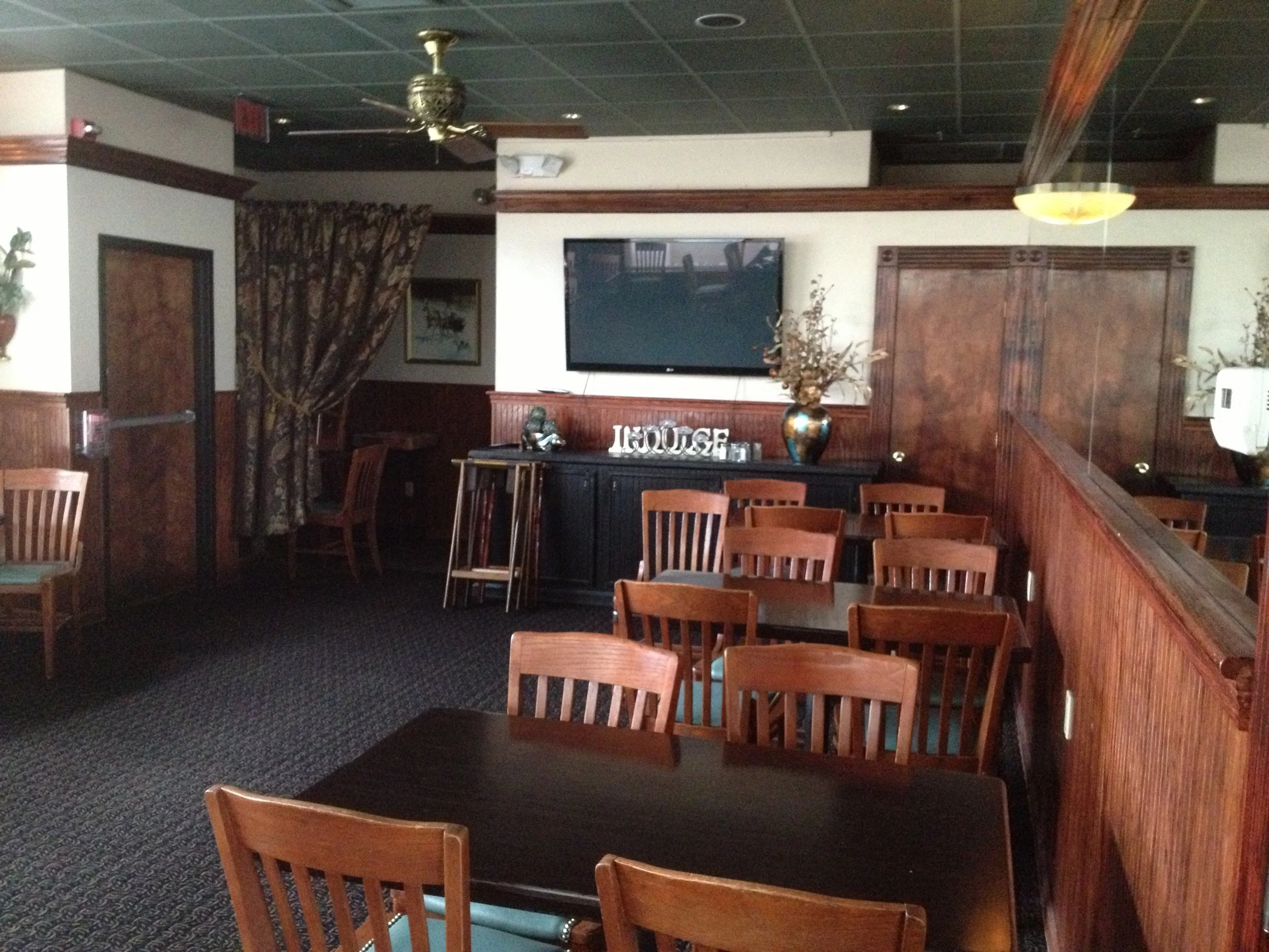  before - dark dated wood, plain walls, low trim, dated chairs, dated carpeting. 