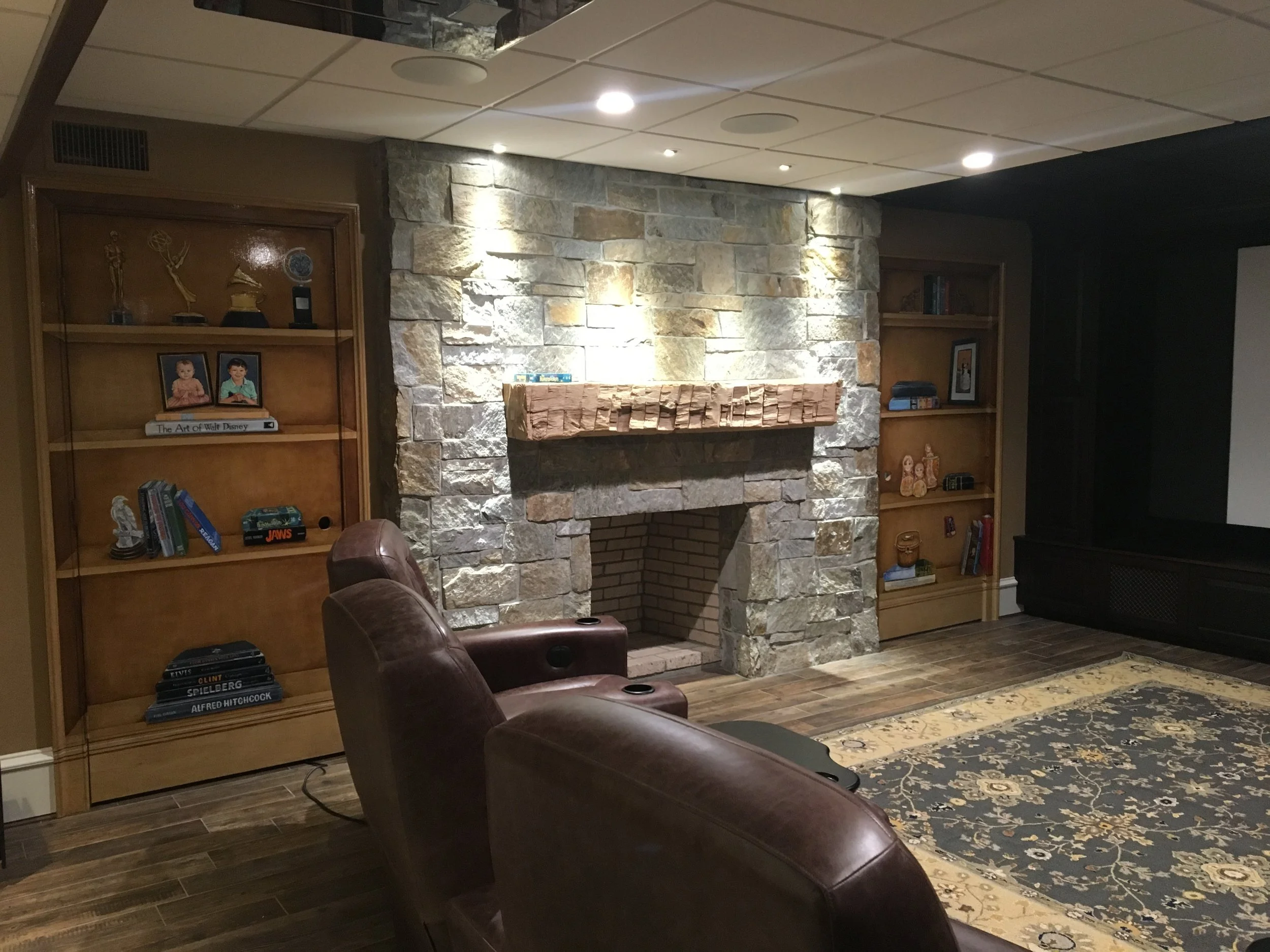  In a home theater/entertainment room, client wanted doors to be unique. Here are the two in the home theater area where I created trompe l'oeil book cases. Treasured personal elements, family portraits, books and movie trivia elements. 