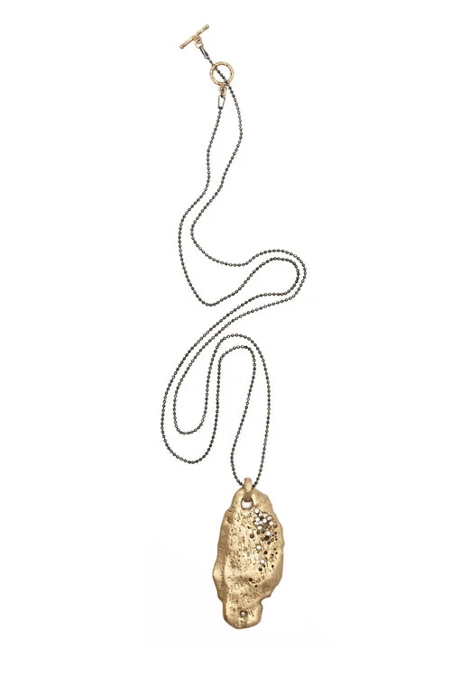 With a beautiful organic sea shell form, this bronze pendant randomly dotted with delicate CZs by Julie Cohn is a chic gift. $395