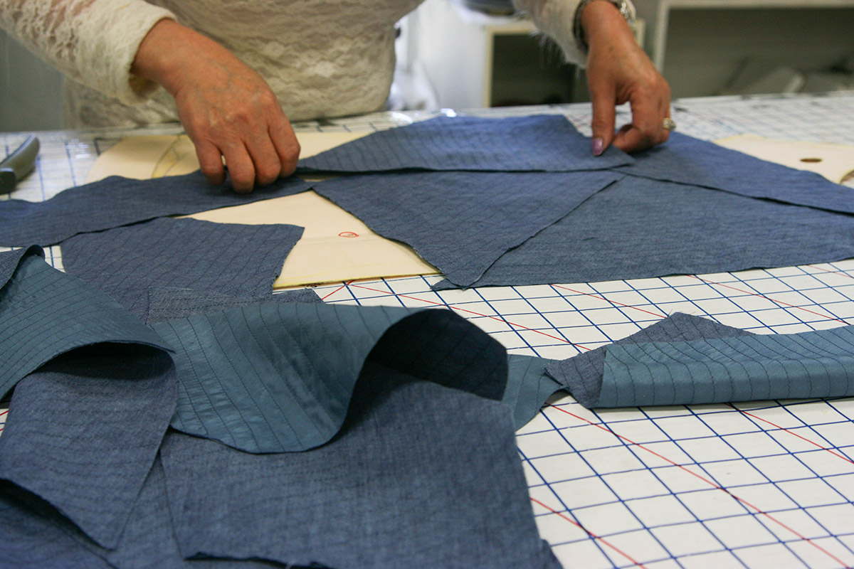 Using the garment pattern as a template, the pieces are laid upon the pattern for general placement.