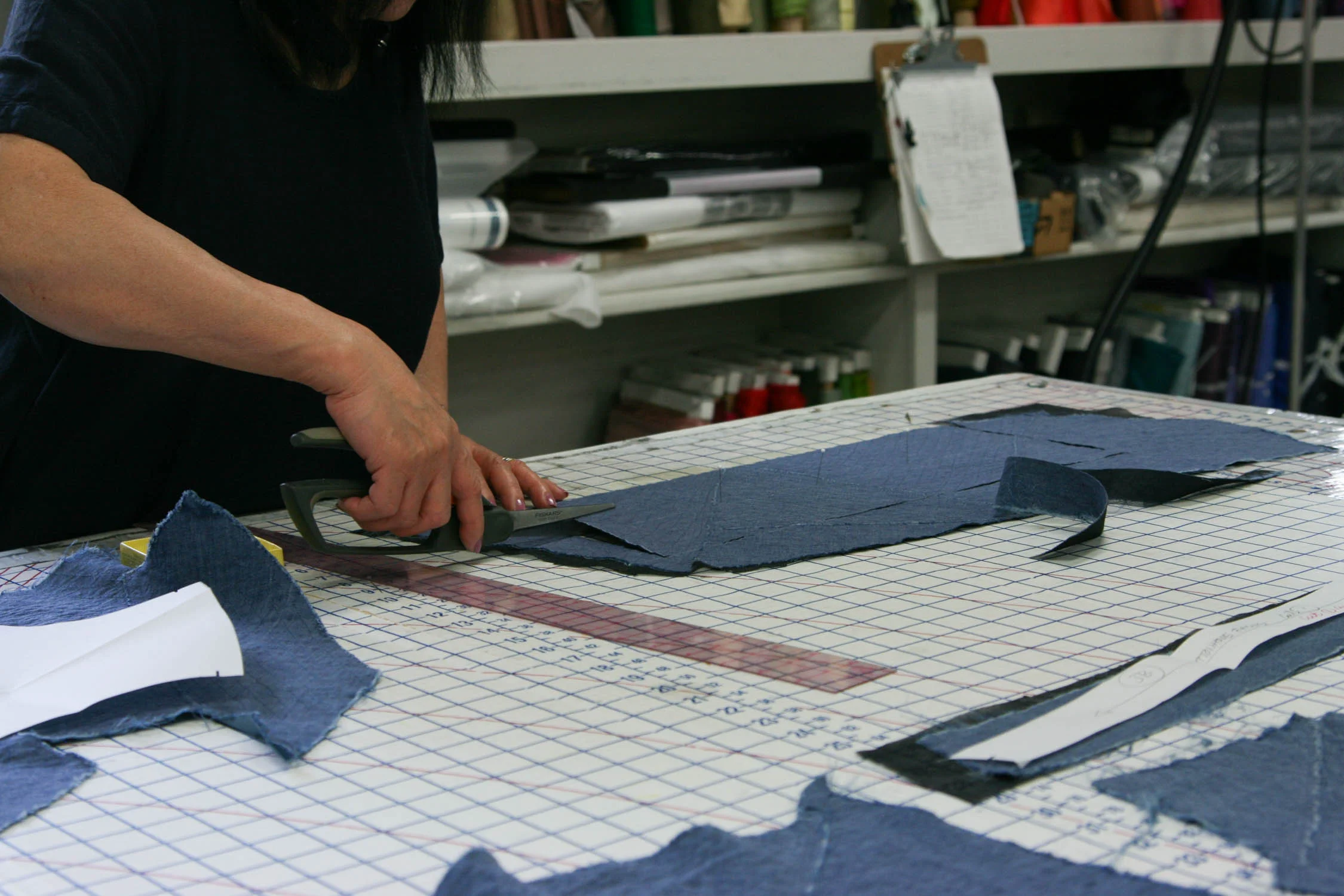 Cutting garment pieces.