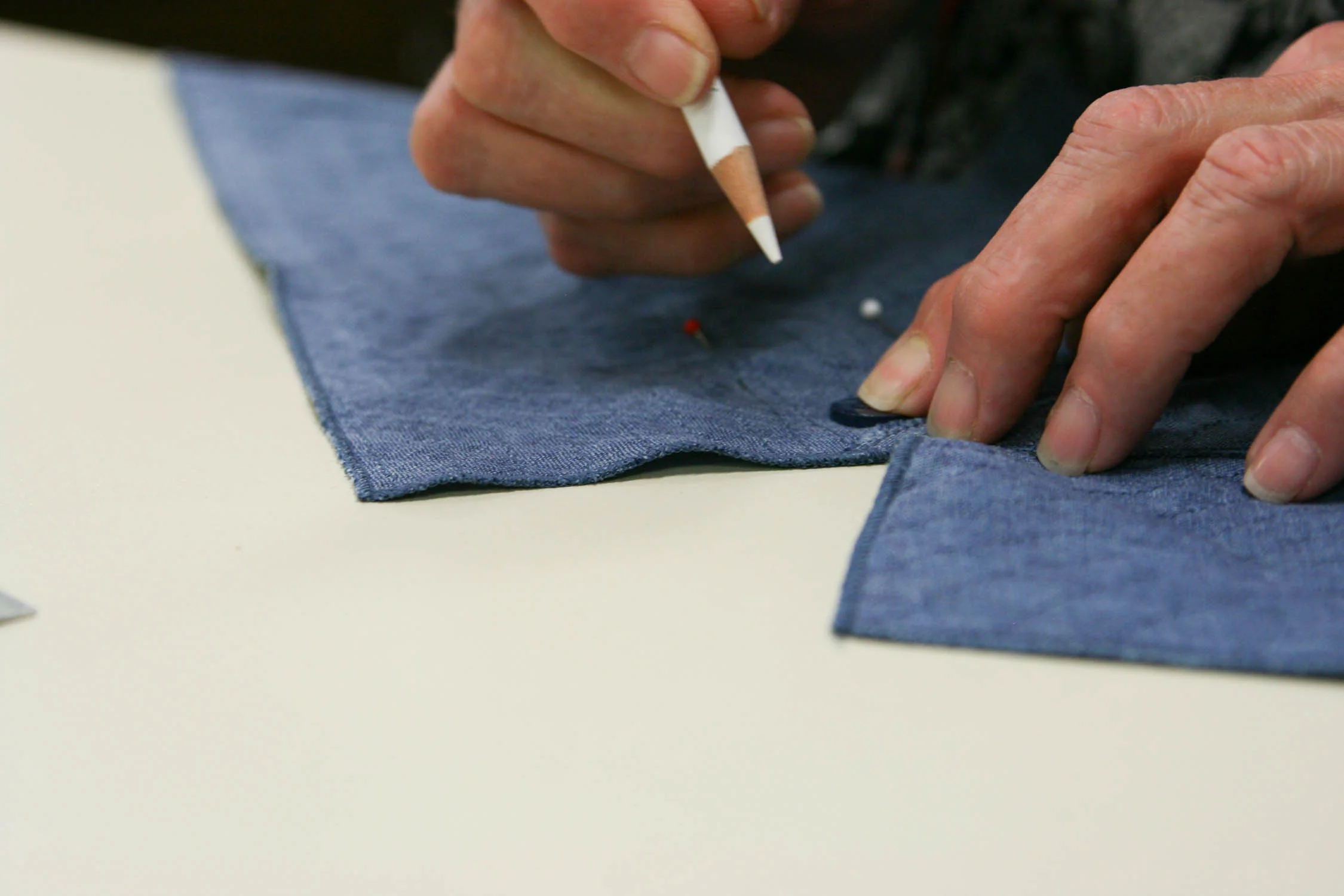Button placements are marked before sewing.