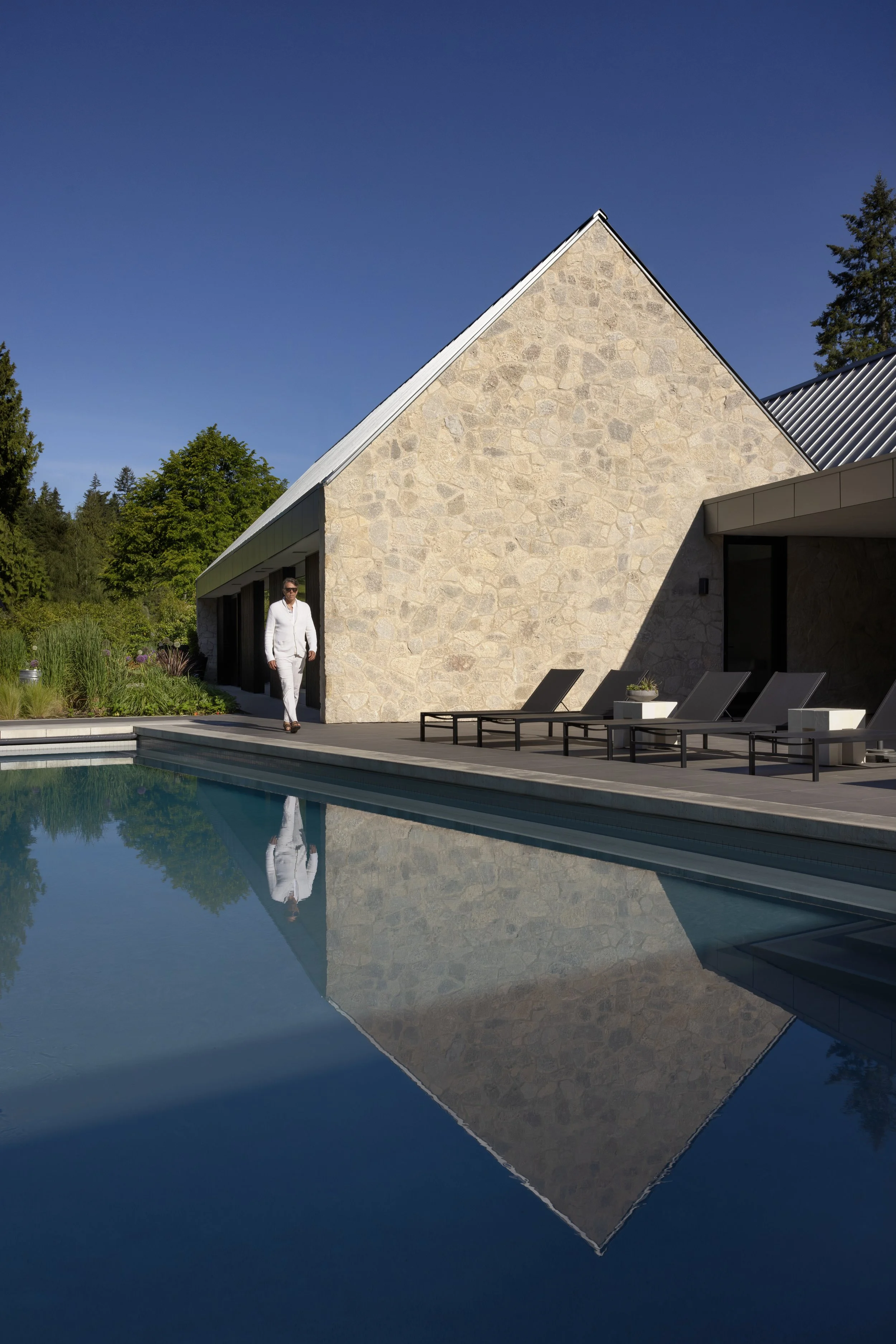  The house itself was conceived as “a collection of wings around a central courtyard with a pool: a bedroom wing, a living wing, a covered outdoor terrace, and a guest house,” says Burgers. “Its form takes cues from stone-gabled European farmhouses, 