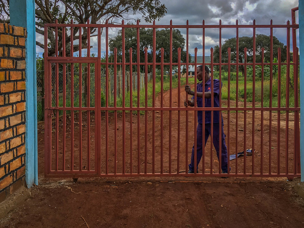 Security guard locking gate.jpg