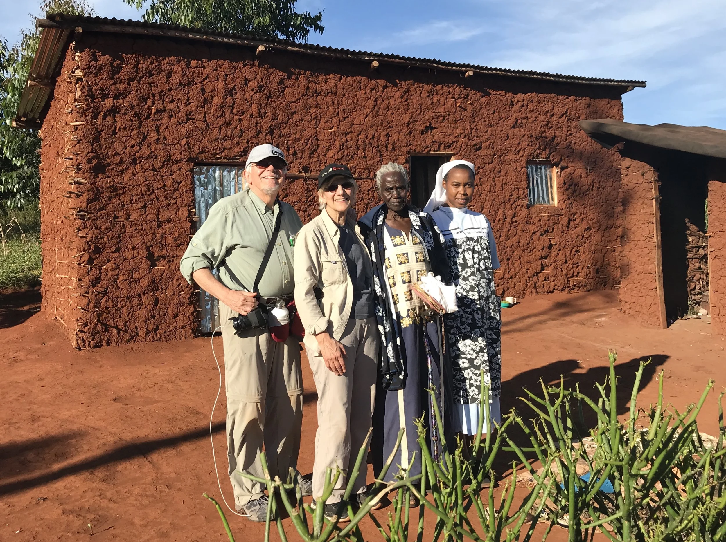 Left to Right: Standing in front of Samia Said's new home are Sergio Burani, Johanna Burani. Samnia Said, and Sr. Dativa Mukebita