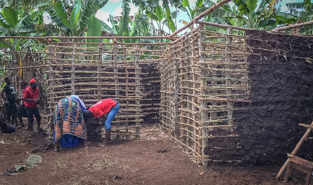 The house building in progress. The house is a stick frame with mud walls