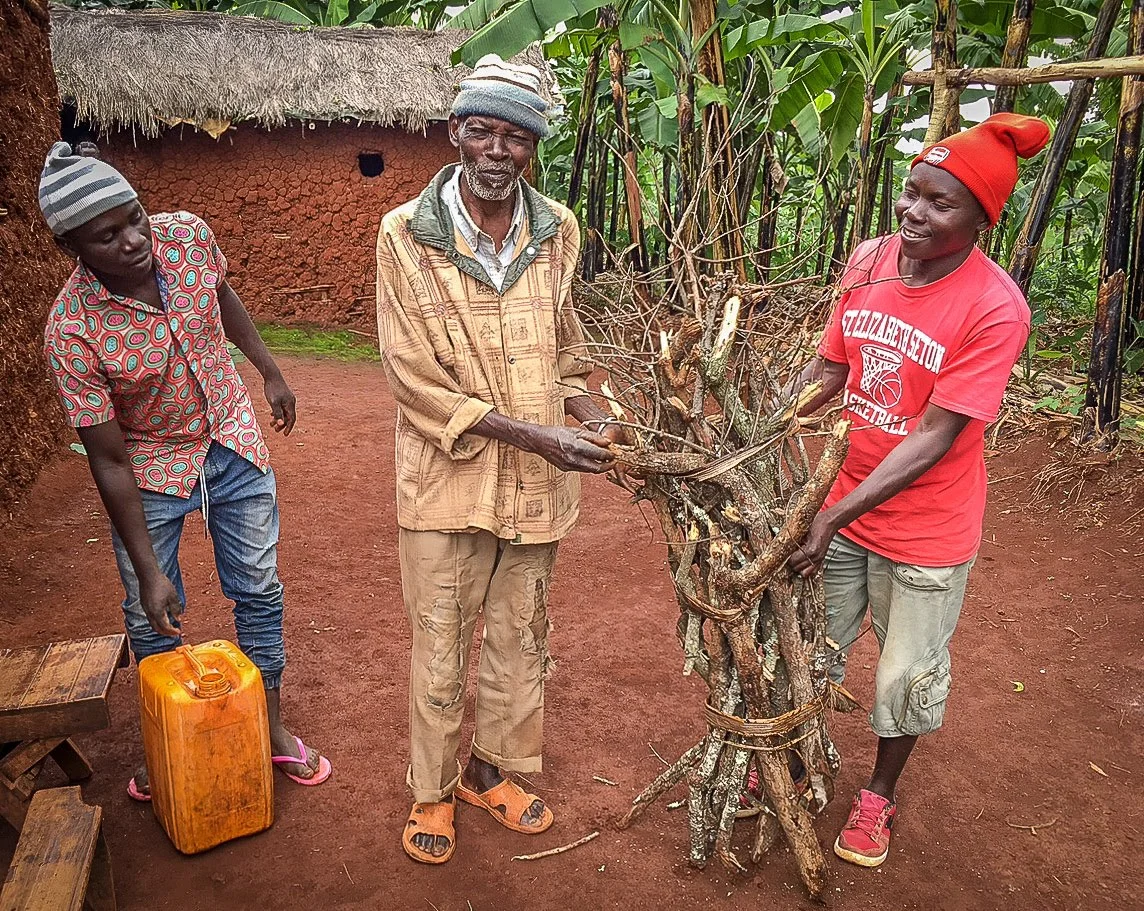One of the elderly men in our program happily receiving water and firewood