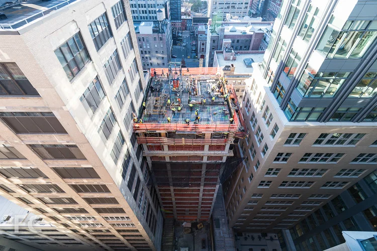 Workers prepare the 15th floor slab of the Vandam Street tower.