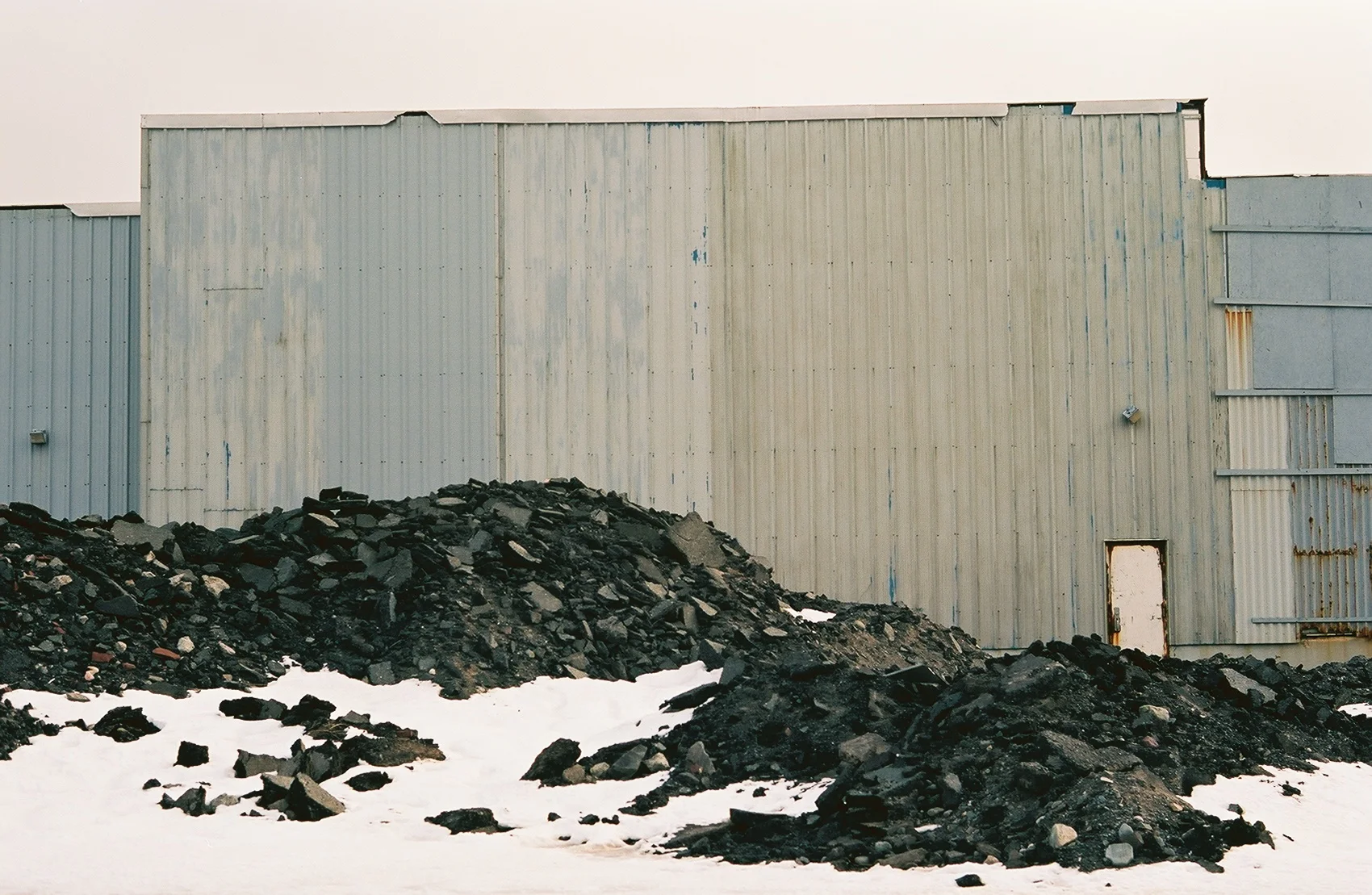 Other buildings slowly crumble. Mounds of excavated soil are also a common site.