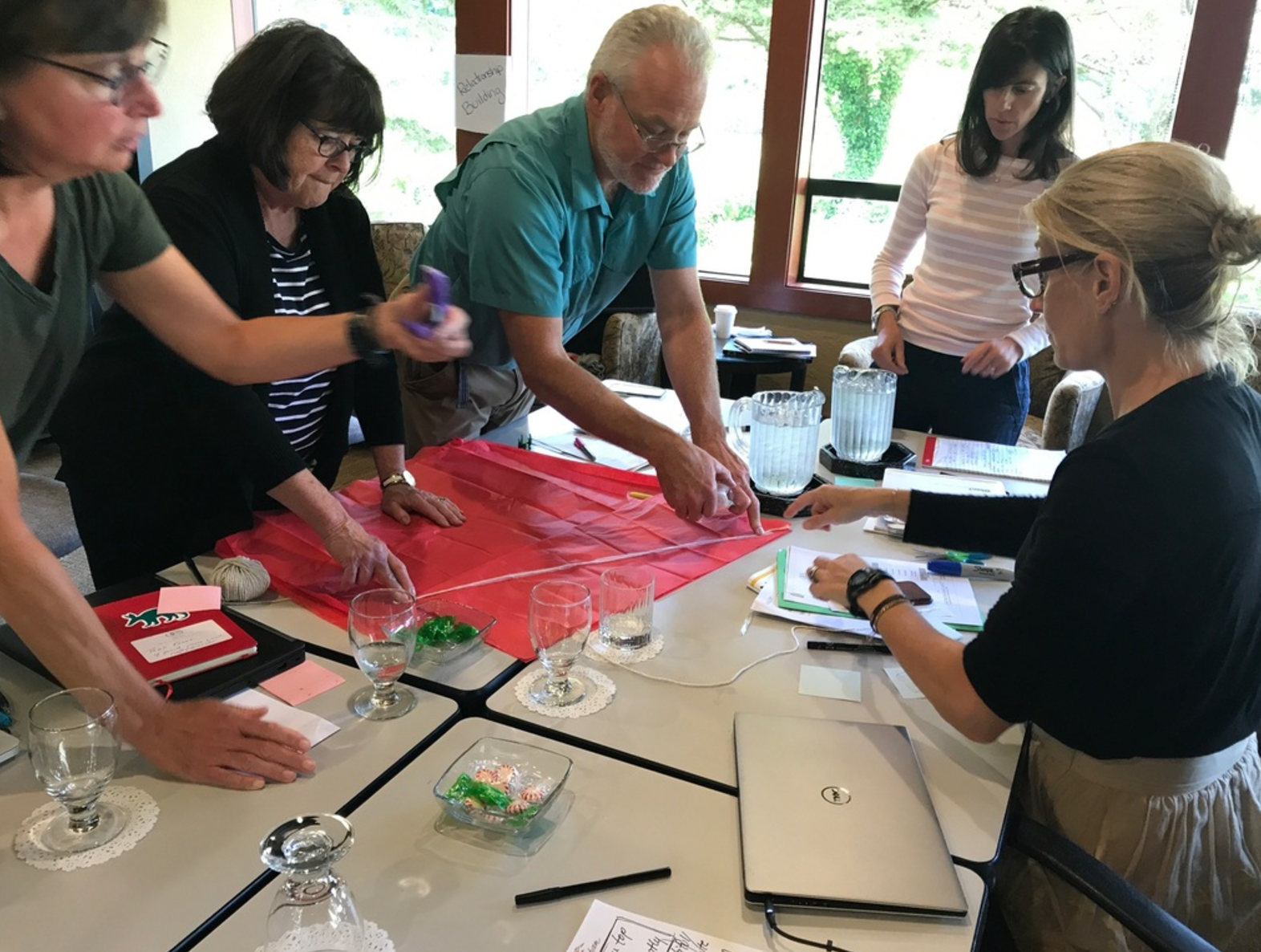 Oregon Episcopal School administrative team designing parachutes during a recent session. Exercises like these help us get in the mindset for innovation and creative risk-taking.