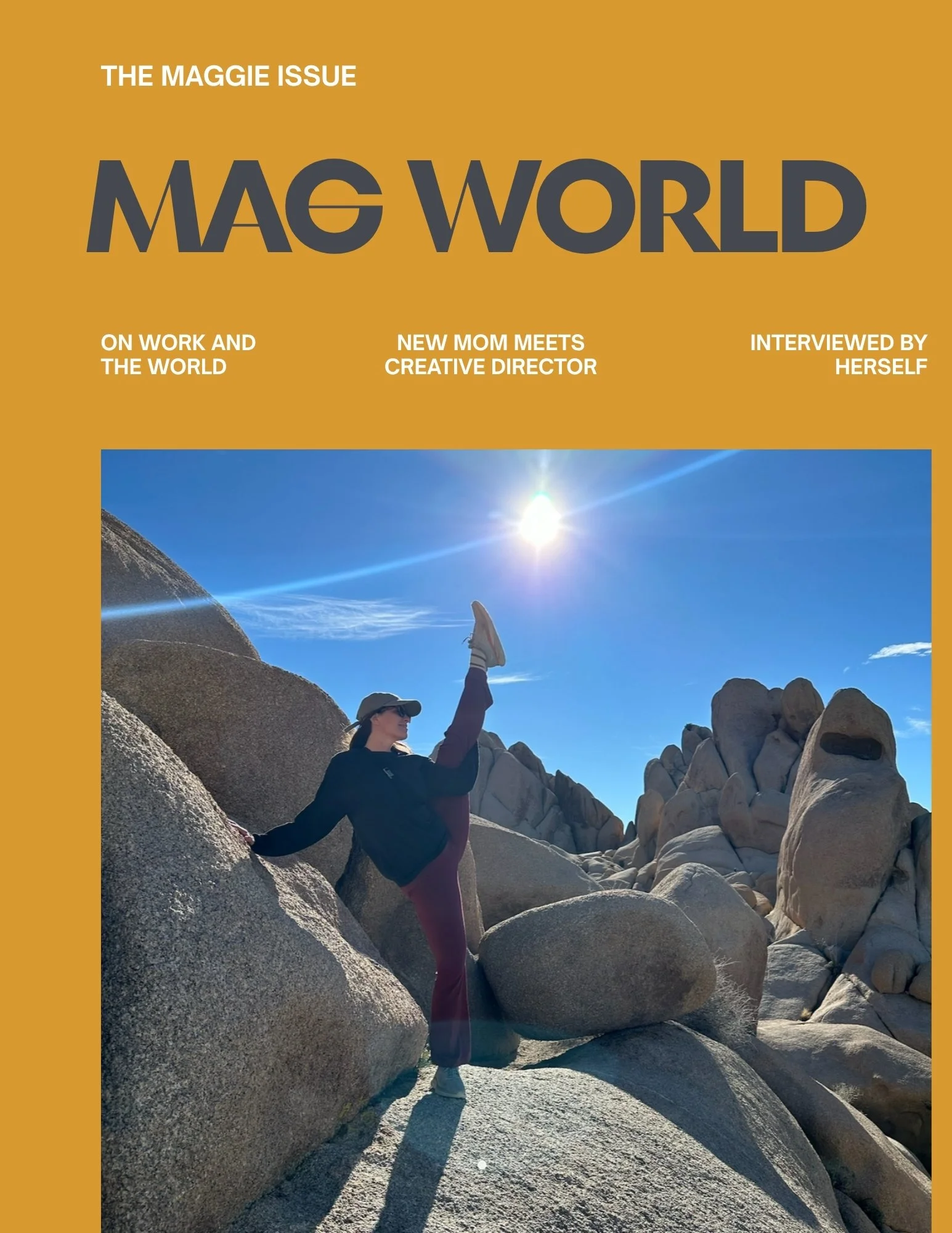 A woman wearing a hat, sunglasses, a dark jacket, and maroon pants standing on large rocks in a desert landscape. She is reaching upward toward the sun, which is shining brightly in a clear blue sky, with a trail of clouds and mountain peaks visible in the background.