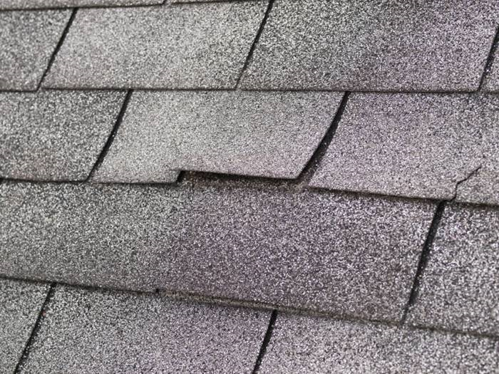 Winter weather can tear shingles off or force moisture underneath them, which damages them further. (Photo: iStock)