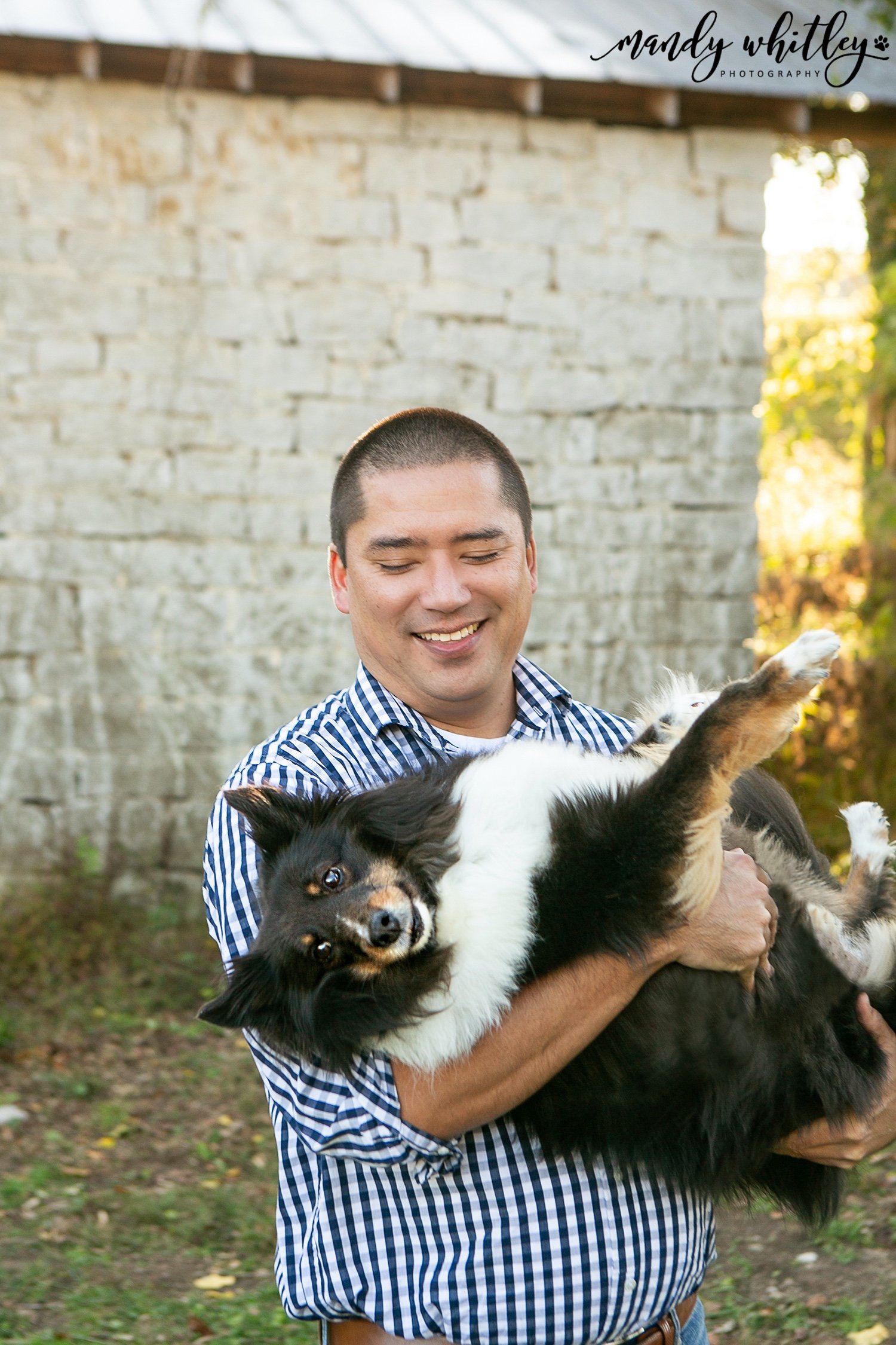 man holding austrailian shepard for photo