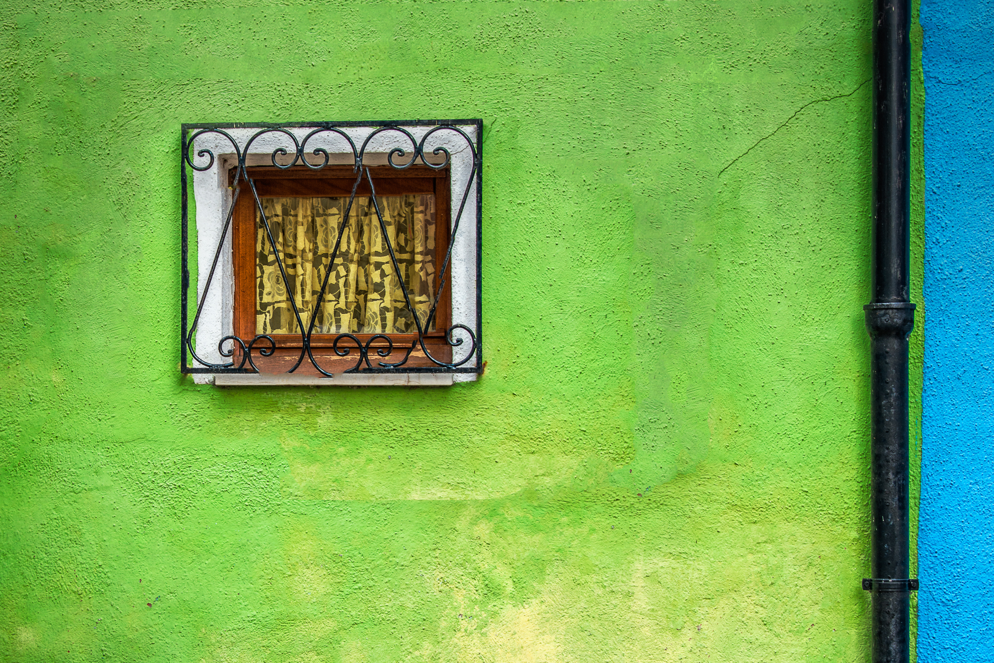 Green Wall, Window and Pipe in Burano Italy