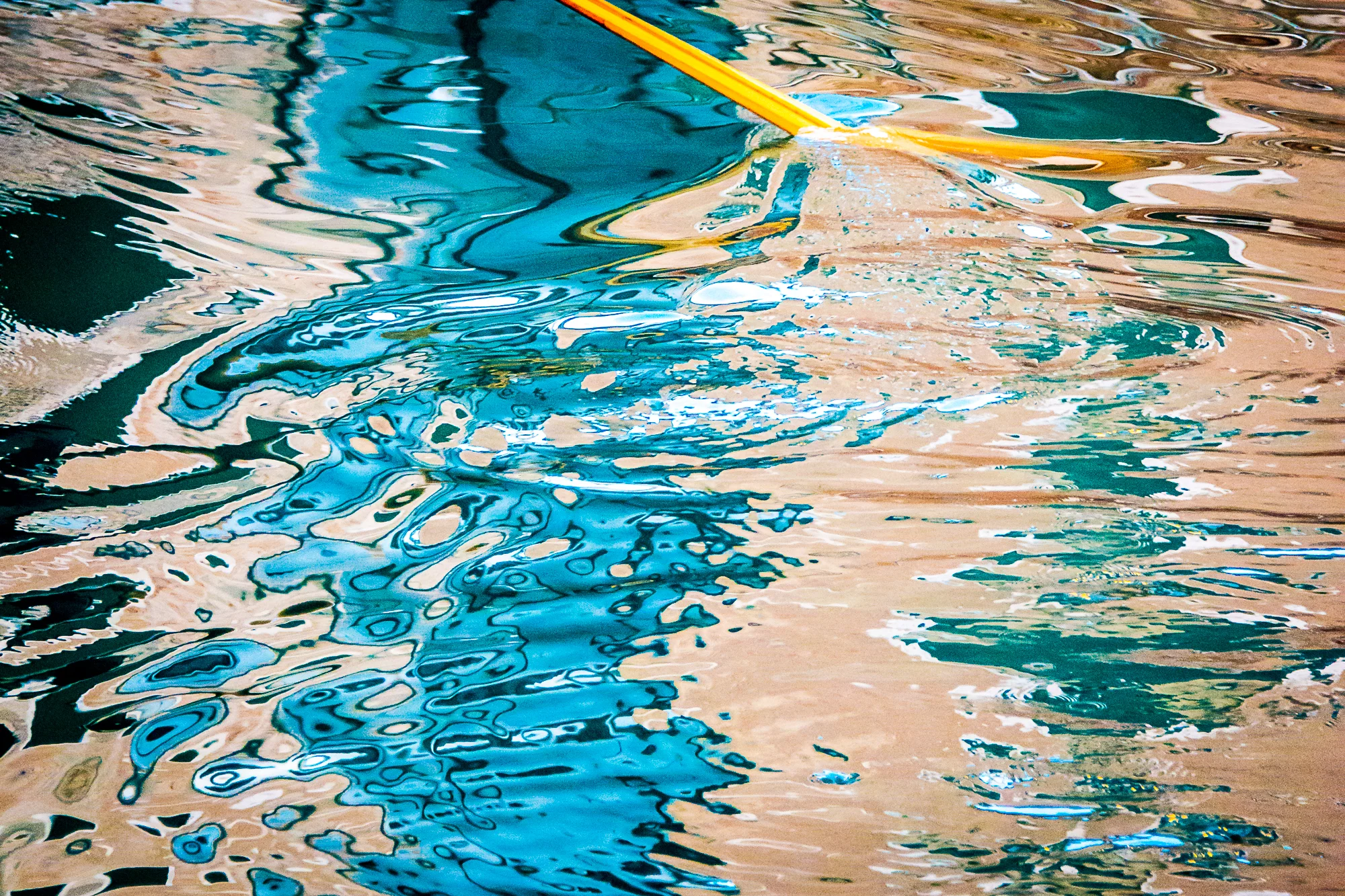 Mercurial-like reflections in a Venetian canal, created by a gondolier's oar