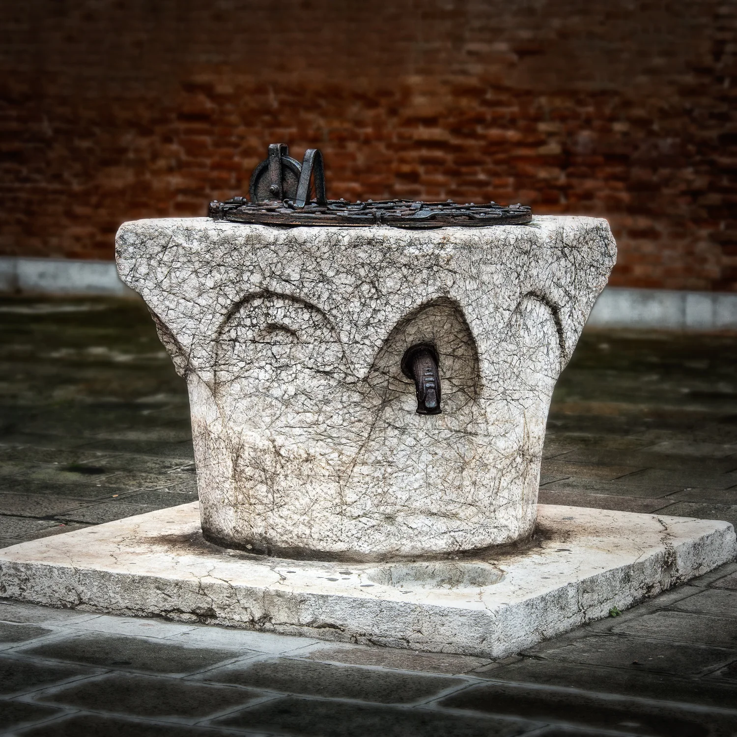 This pozzo has a lifting pulley for lifting water buckets, as well as a spigot with basin, for which the plumbing is a mystery to me.