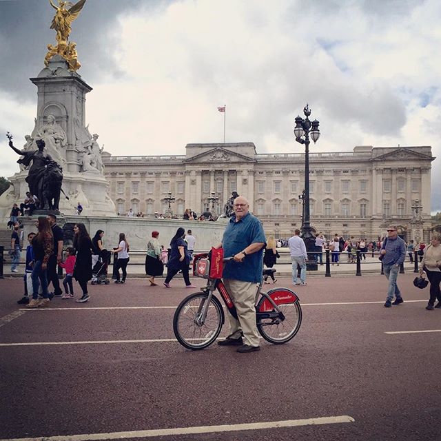 Spending time bike riding past Buckingham Palace in London.