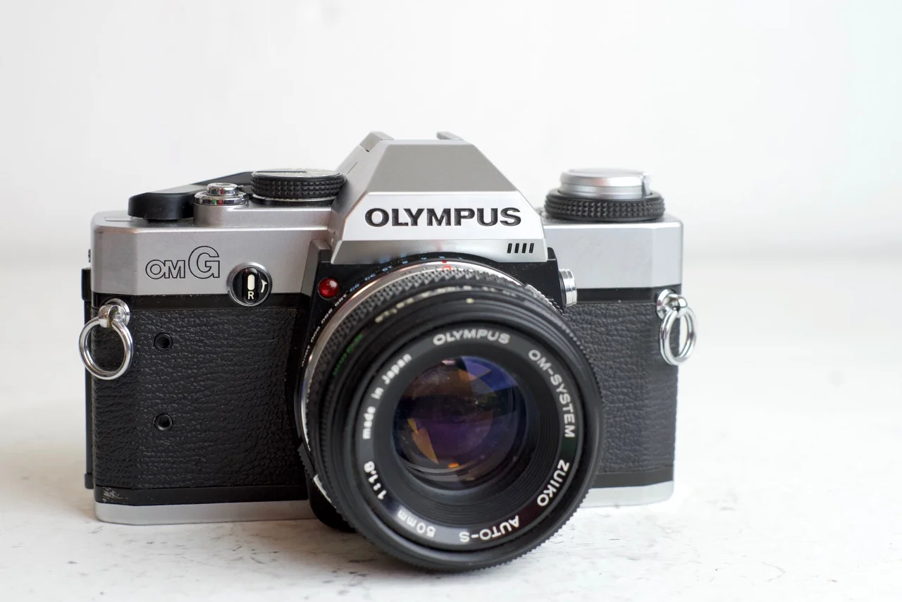 Olympus OMG 35mm Film SLR Camera with Olympus Body Cap and Batteries - aka OM-20