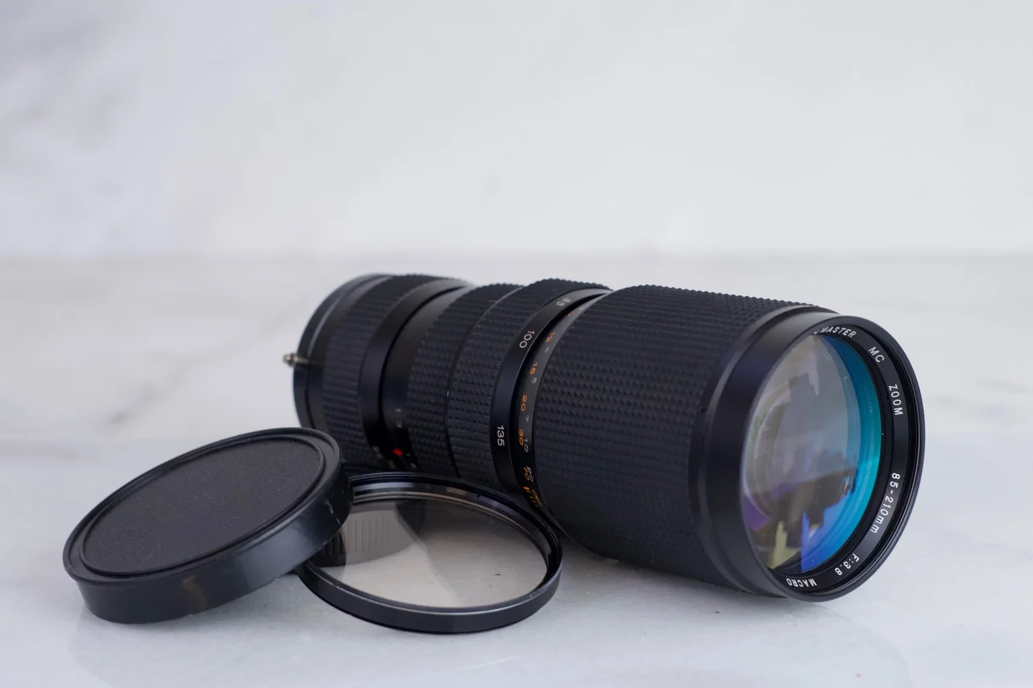 Olympus OM Mount Promaster MC 85-210mm f/3.8 Zoom Lens for Olympus Cameras with Caps and UV Lens