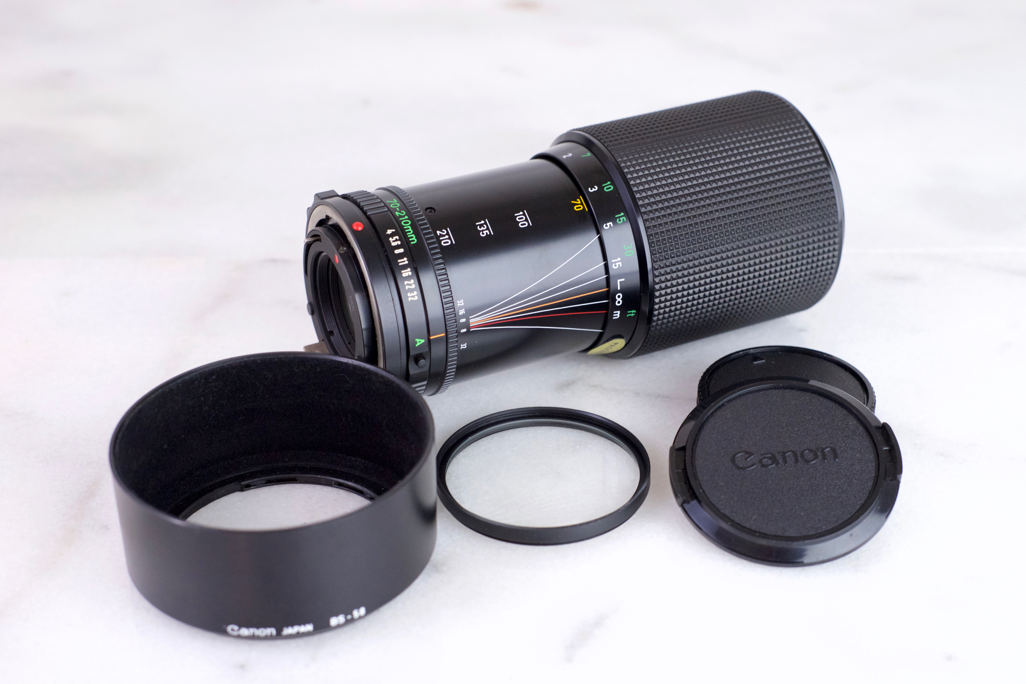 Canon Zoom Lens FD 70-210mm F/4 with Caps, UV Filter and Lens Hood- Macro Focusing Legacy Lens for FD Mount Canon Cameras