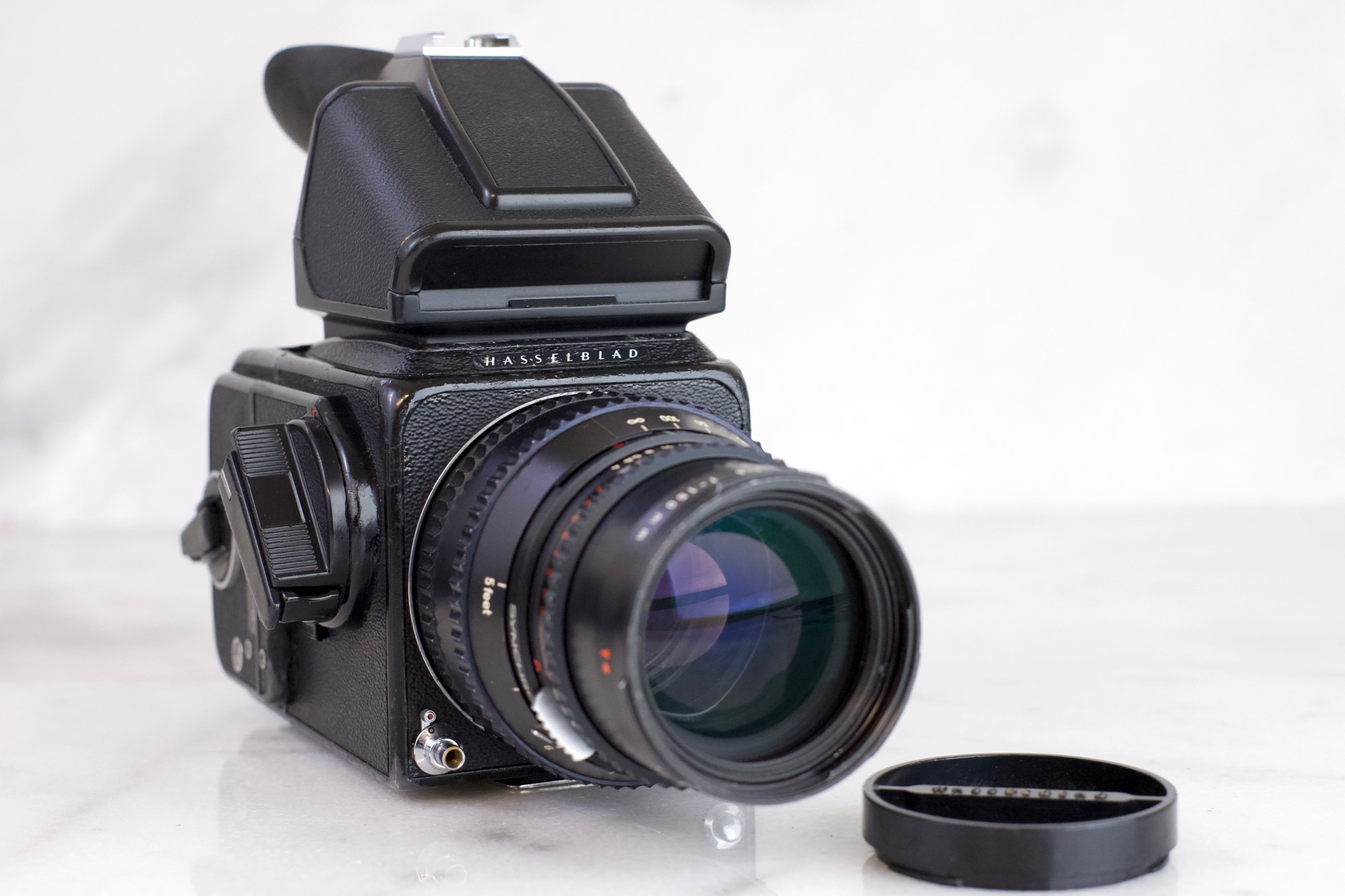 Hasselblad  CM with Carl Zeiss Sonnar T* mm F Lens, A Film Back,  Prism Viewfinder, Lens Cap — F Stop Cameras