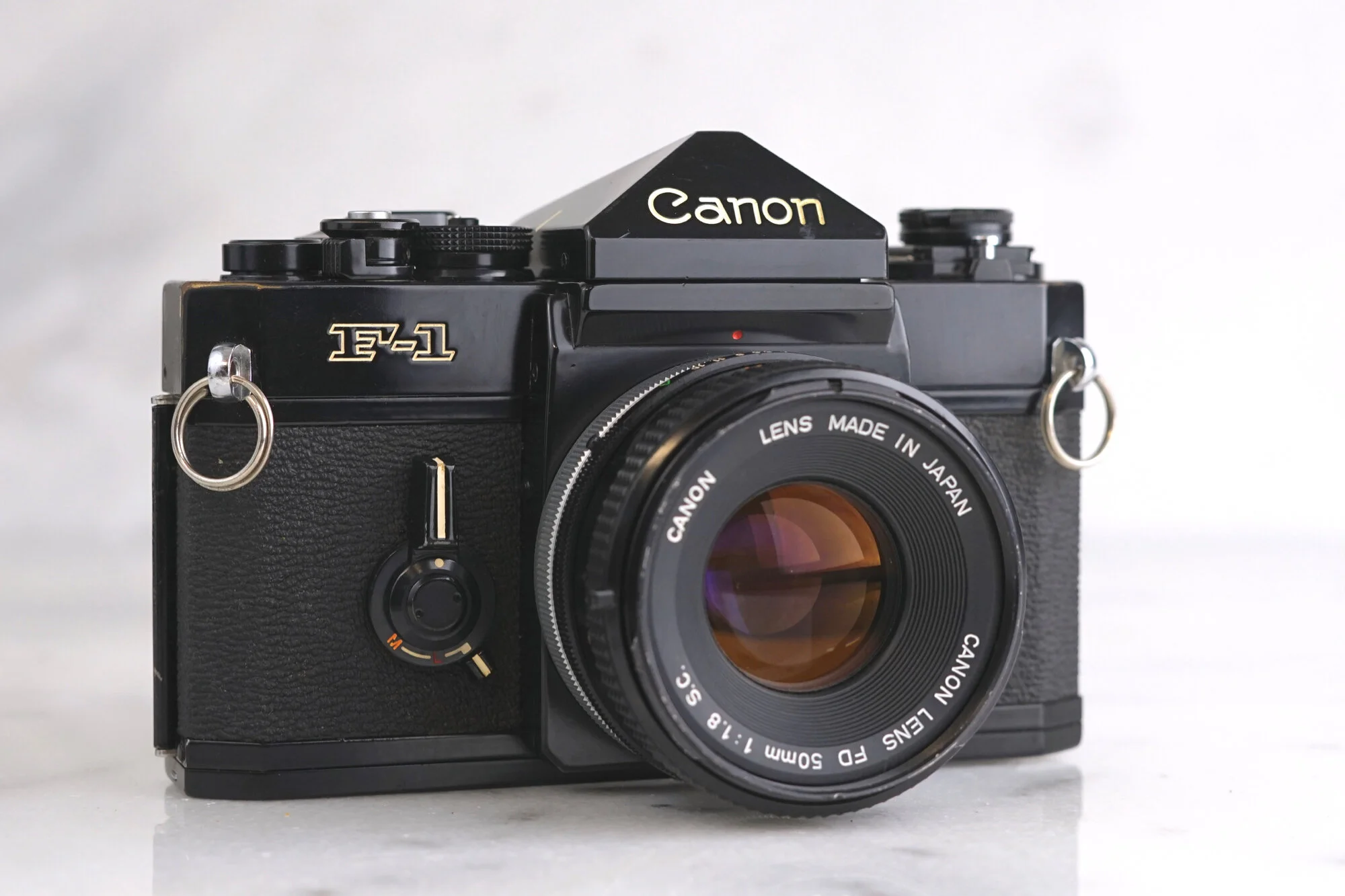 Canon F1 35mm Film SLR Camera with Canon FD 50mm F/1.8 Fast Prime Lens, Eye Level Finder, and Batteries