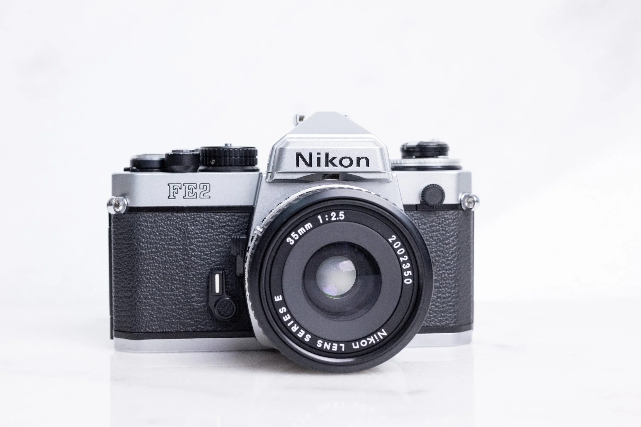 Nikon FE2 Titanium Shutter Model 35mm Film SLR Camera and Nikon Series E 35mm F/2.5 Prime Lens