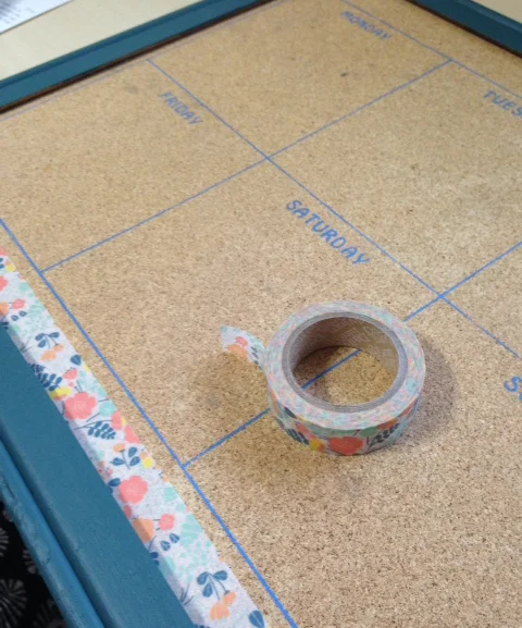 Added two strip of cute washi tape to the top and bottom of the cork board.