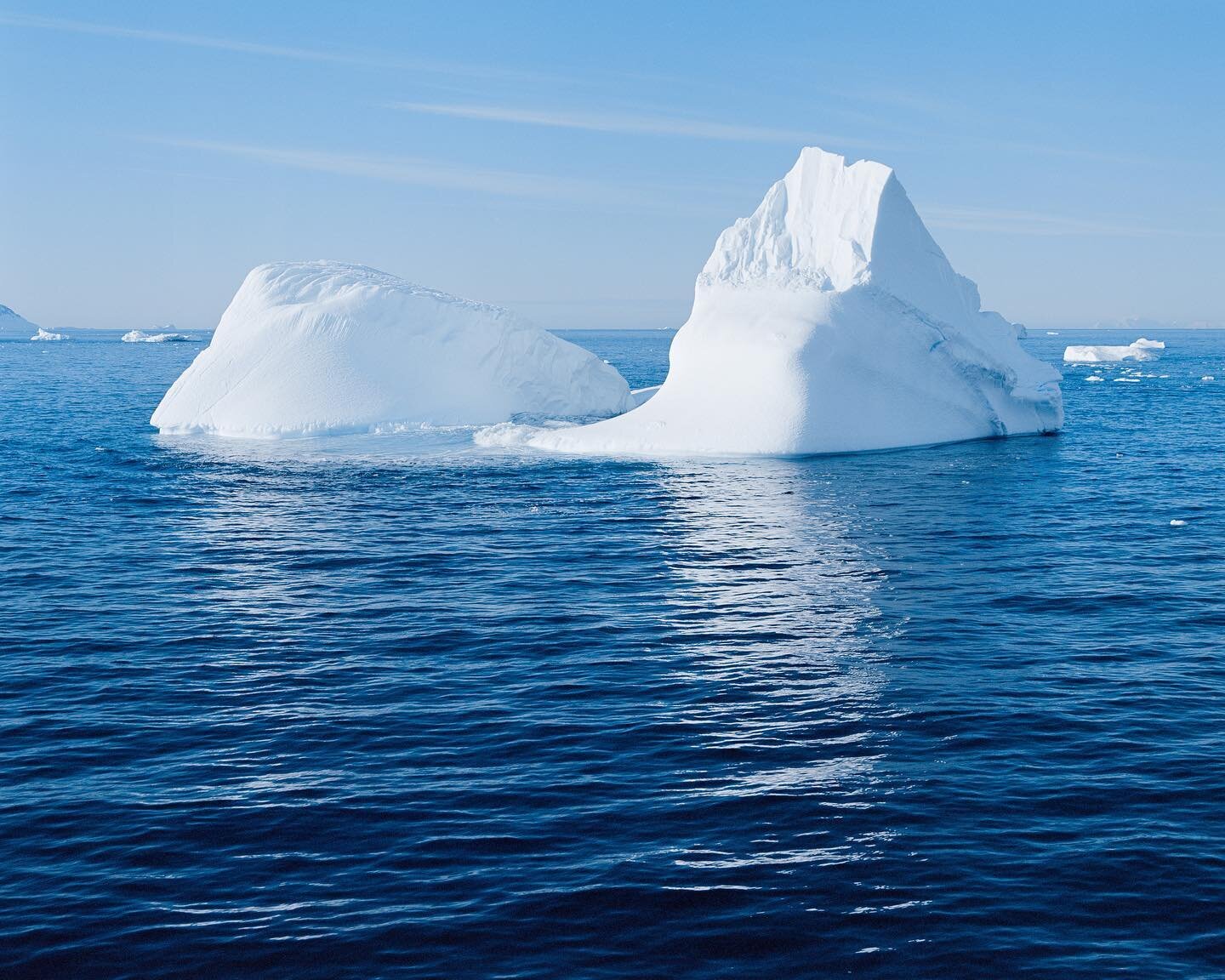 Iceberg Near the Antarctic Sound  These ghostly giants drift silently by the ship, rolling, flipping, carving away at themselves until their inevitable fate at sea.  Pentax 67ii, 75mm, Kodak Ektar, drum scanned @tangodrumscans