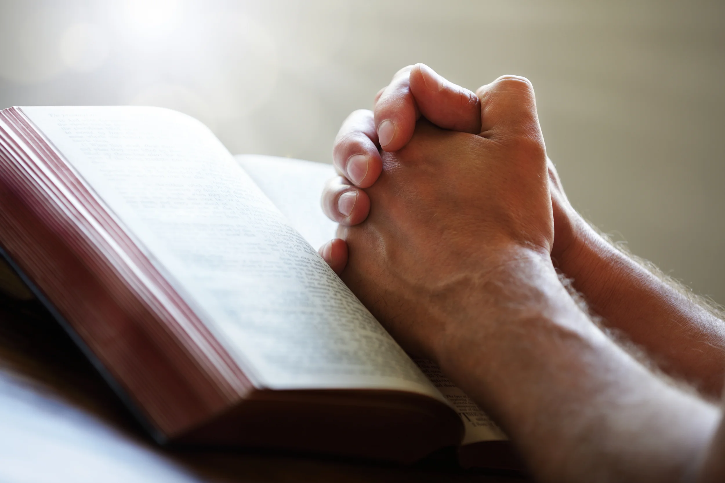 bigstock-Hands-folded-in-prayer-on-a-Ho-47921843.jpg