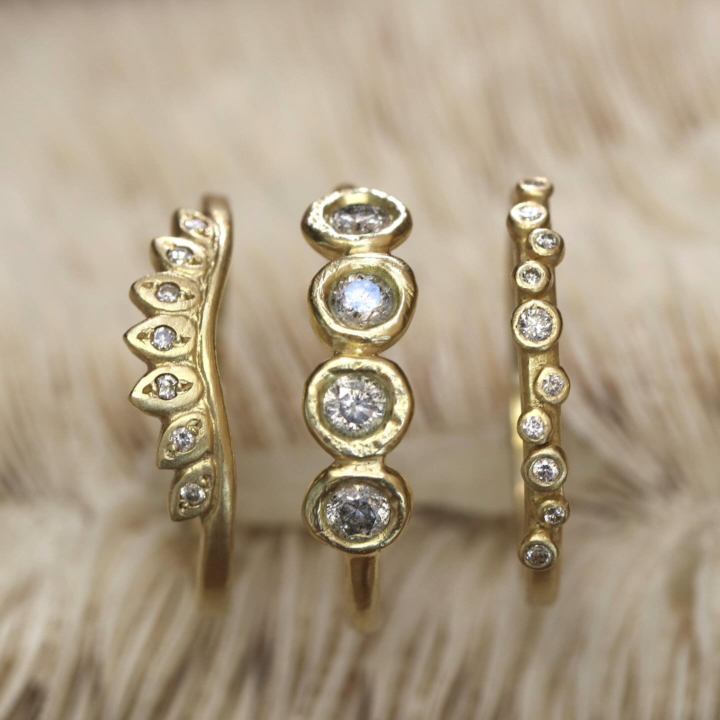 A whimsical trio of bands in warm recycled gold with a mix of white and gray diamonds. Perfect to add to your stack or complete a bridal set. ✨

Left to right:
Laurel diamond band
Erosion line gray diamond band
Galaxy diamond band

#stackingbands #ha