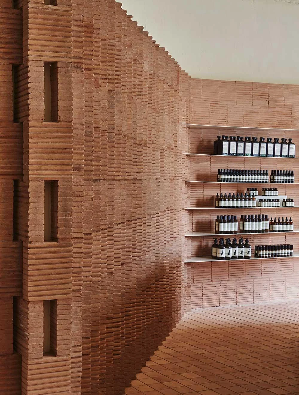The interior of the new Aesop boutique in Brooklyn is made from red bricks inspired by the neighbourhood’s classic brownstone buildings.