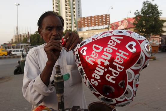 A vendor inflates a heart-shaped balloon in the Pakistani city of Karachi, on Feb. 10, 2016. Credit: Akhtar Soomro/Reuters