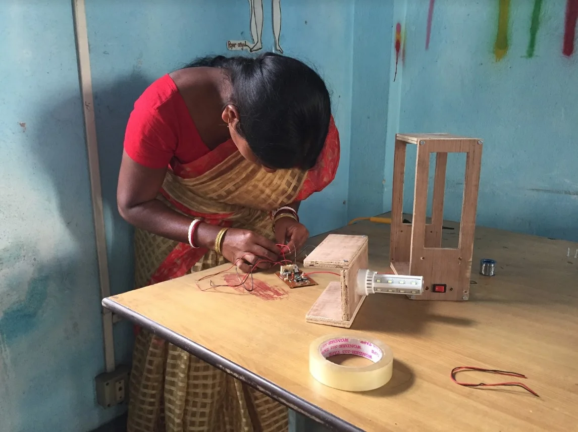 Indian woman works on a sustainable solar lamp. Credit: Ambra Dentella