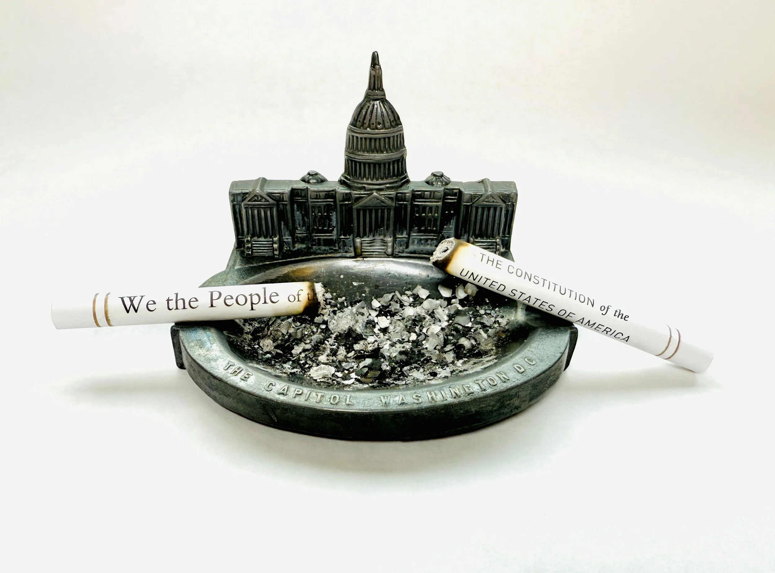 "Authoritarian Souvenir (up in smoke)"  is a part of the Take One Action exhibit presented by Art At A Time Like This