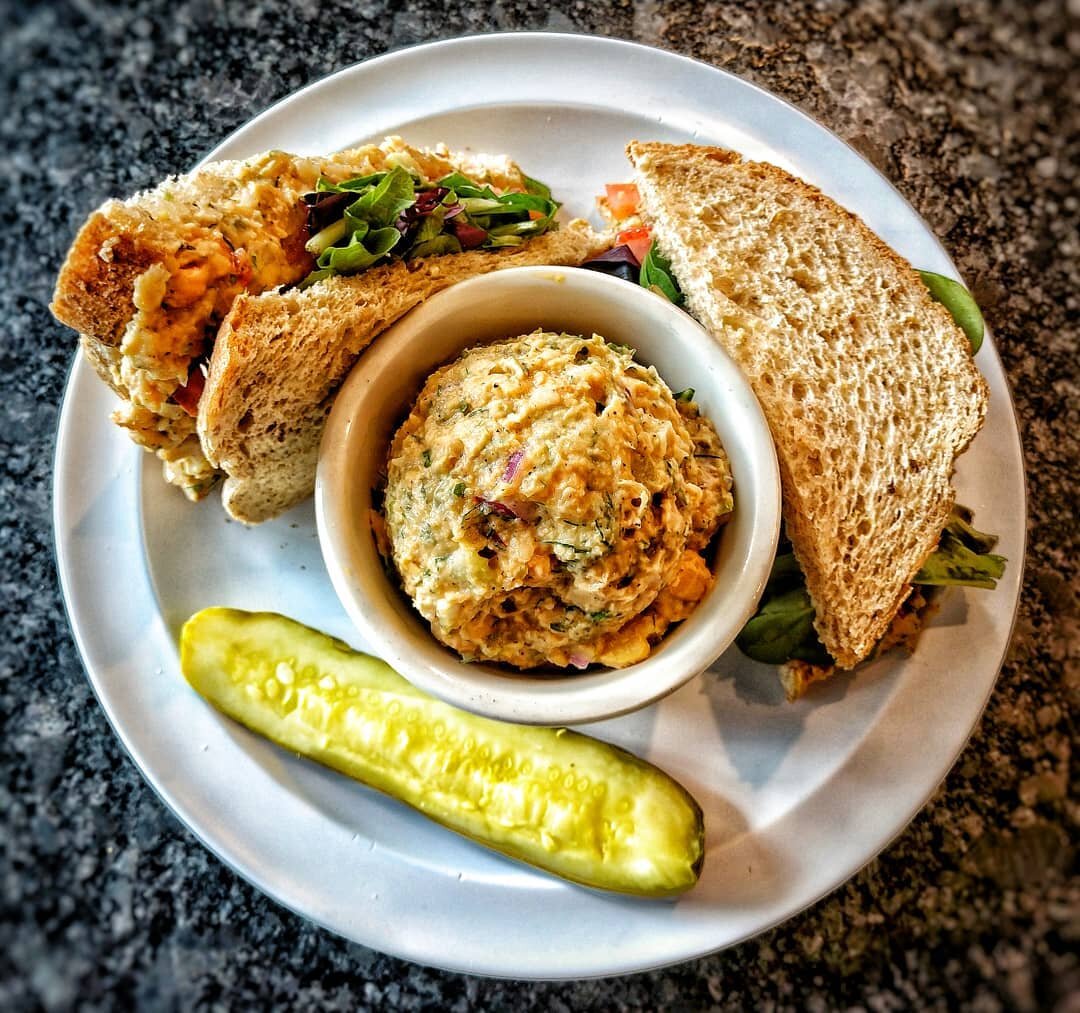 Here comes a handsome new vegan option!⁣
⁣
Now serving our house made chickpea salad sandwich. Made with our vegan garlic aioli, spices and finely diced veggies served with tomatoes and spring mix on your choice of bread! Try one out to fill yourself