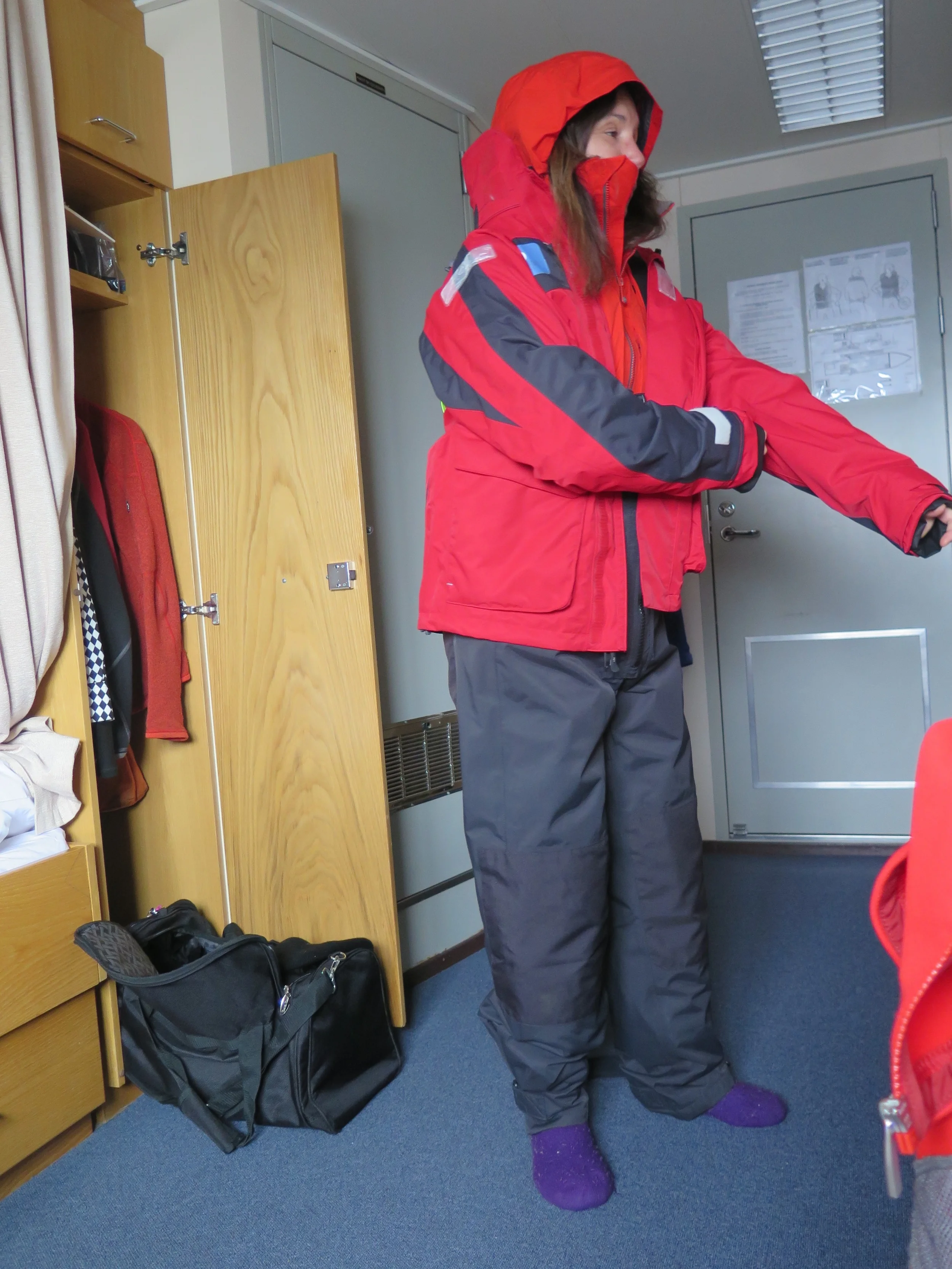 Pamelia tried on the waterproof gear provided by the expedition team: hooded jacket, overalls and tall rubber Wellington boots. We rented heavy-duty waterproof backpacks to carry our cameras and extra pieces of warm clothing. We would end up scrubbing and disinfecting our gear—"bio-securing" it, to use expedition leader Boris Wise's term—before and after every visit to shore, to avoid spreading microbes or invasive animal or plant species to delicate island environments.