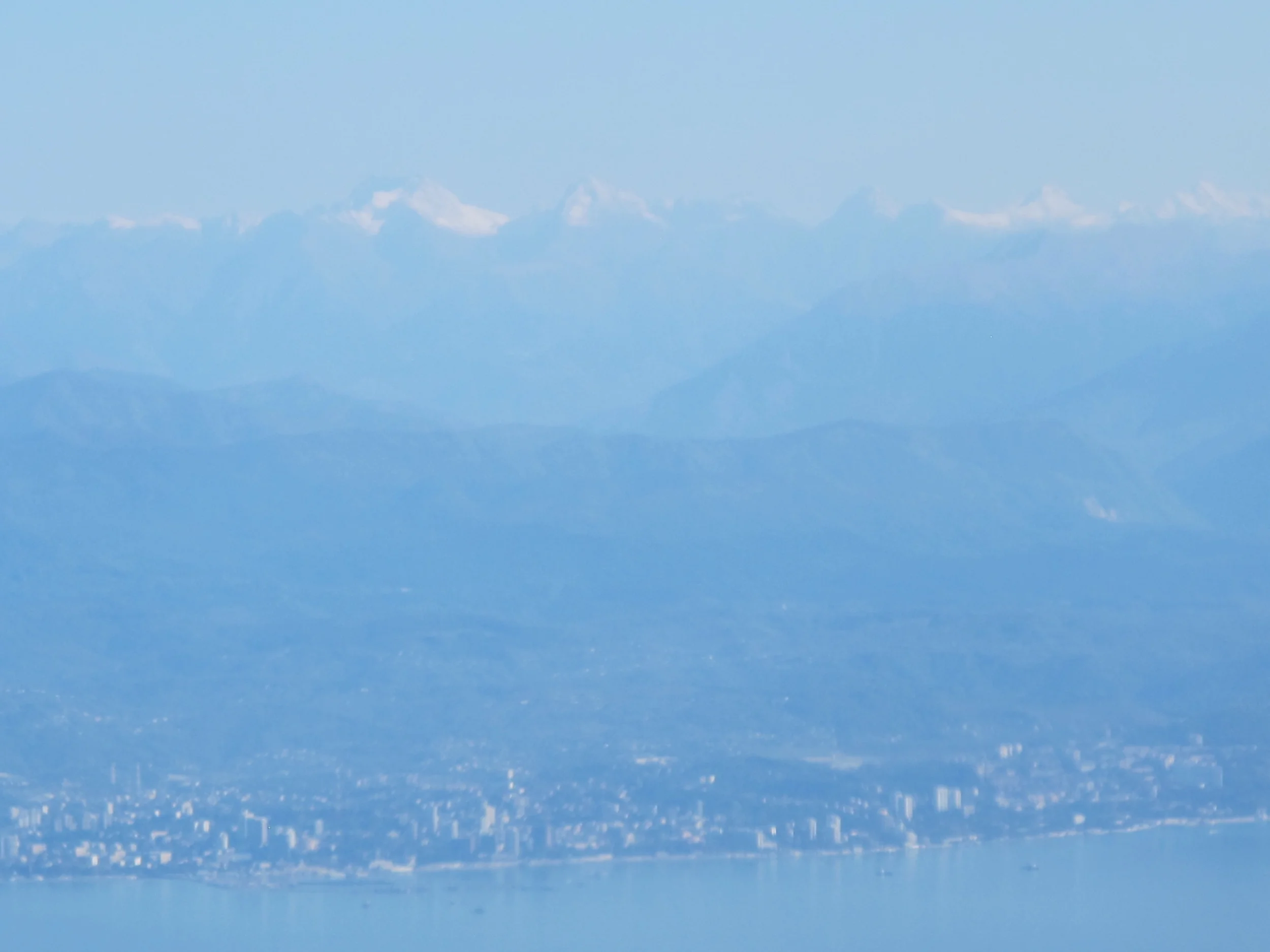 Pamelia took this shot as we neared Sochi after a two-hour flight from Moscow. Those are the Caucasus Mountains rising behind the city. Sochi bills itself as the world’s longest city—it runs for 145 kilometers (90 miles) along the Black Sea—and the coastal Olympic complex in the previous photo is about 25 miles south of downtown. Basically, the entire Olympics will take place either south or inland (up the mountains) from the core of the city.