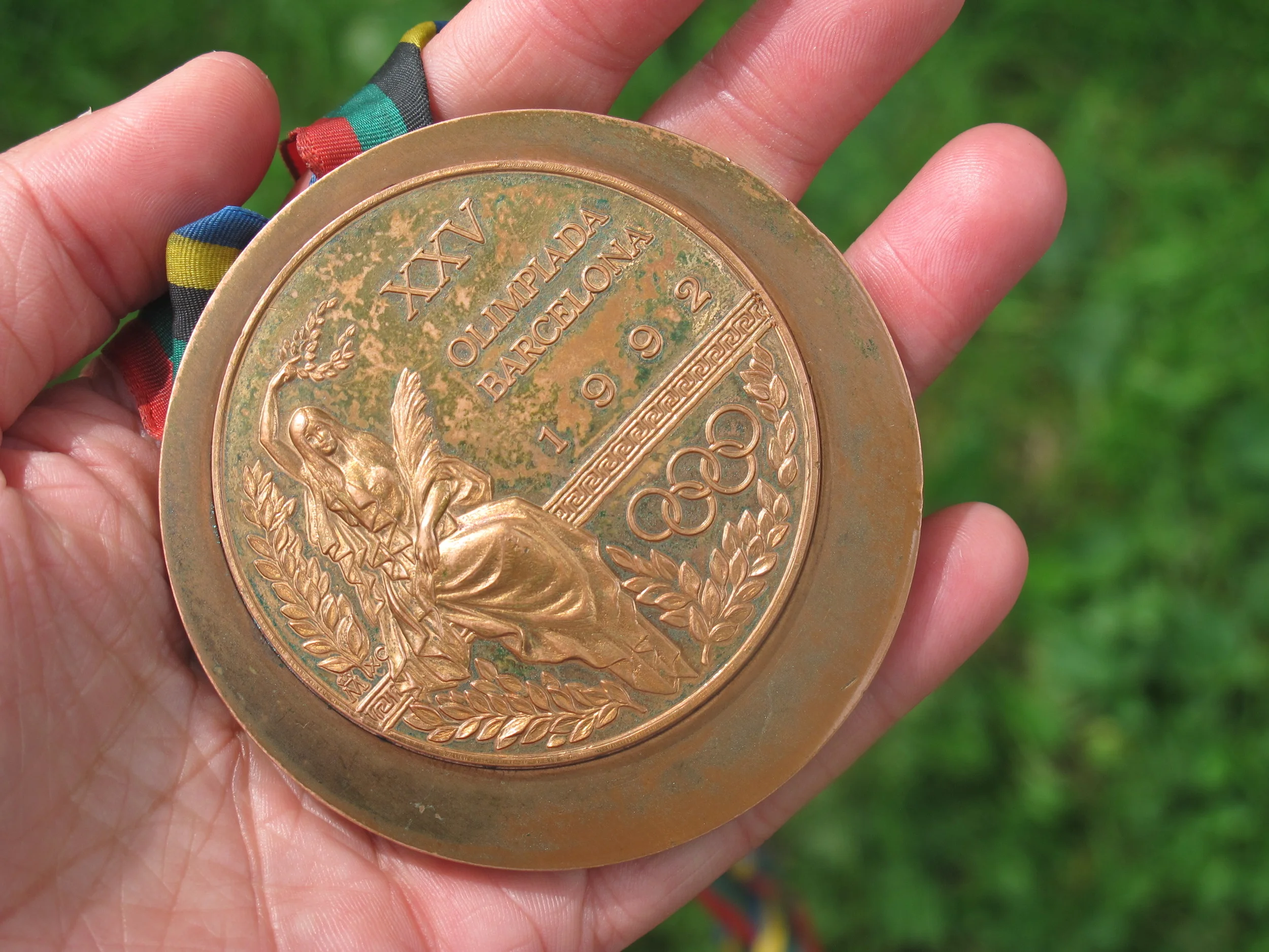 Lynn brought along her 1992 Olympic bronze medal, which she won in the 10,000 meters. I gave the young YMCA runners paper and pencils so they could do rubbings of it.