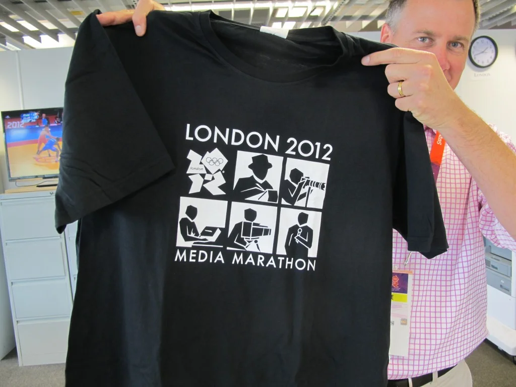 Organizers are selling T-shirts aimed at the 20,000 members of the media (TV people, mostly) here to cover the Games. That’s one of our writers displaying his. If I buy one, I guess I could wrap it around the torch for padding in my suitcase.