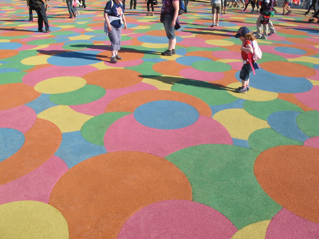 Here’s that area of overlapping colored dots. Kids—and some adults—can’t resist trying to jump from one dot to another of the same color. The surface is made of recycled sneaker soles.