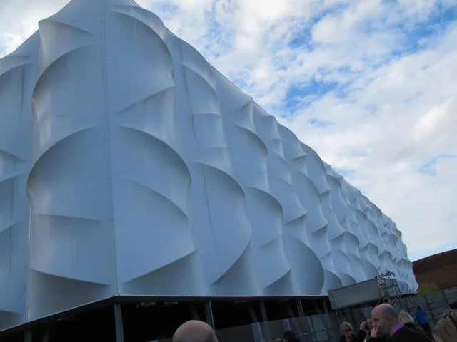 Perhaps you’ve heard the news that the U.S. Olympic men’s basketball team gathered for the first time this week to start preparing for the London Games. This is the temporary arena in which LeBron, Kobe and the gang will play their first-round Olympic games (took the photo when I visited last fall). A green-designed structure, the arena is made mostly of recyclable materials, and after the Olympics end it will be dismantled and either recycled or rebuilt elsewhere.