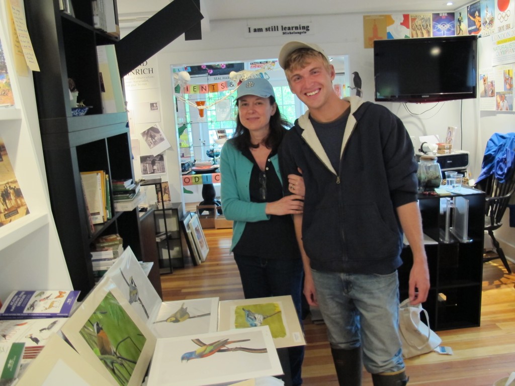 Luke with Pamelia and some of his paintings.