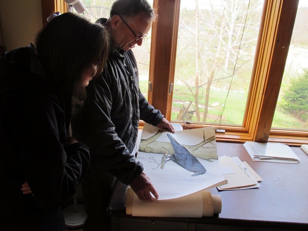 Bernd showing Pamelia and me art pieces in his studio.