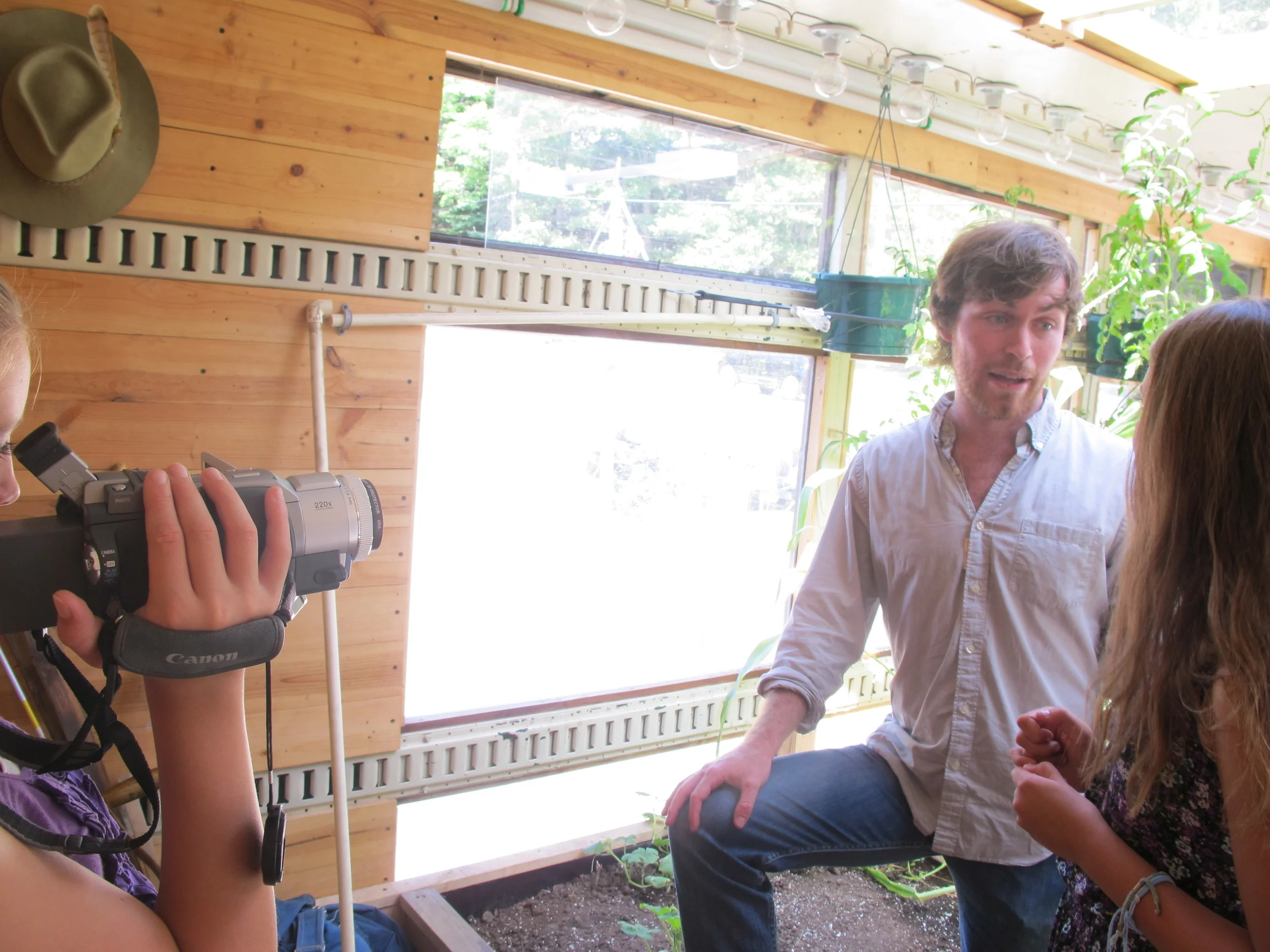 Lily the 12-year-old camerawoman and Anthea the 14-year-old reporter ventured inside the mobile greenhouse to interview Compass Green co-founder Nick Runkle for our Earth News kid-reporter program.
