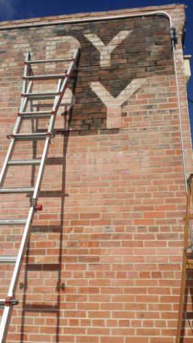 The approach of lightly touching up the lettering with diluted paint.&nbsp;