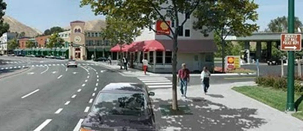 Rendering of gas station with pumps behind the building, fitting in with the context of downtown.